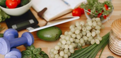 A vibrant composition of fruits, vegetables, and fitness items promoting a healthy lifestyle.
